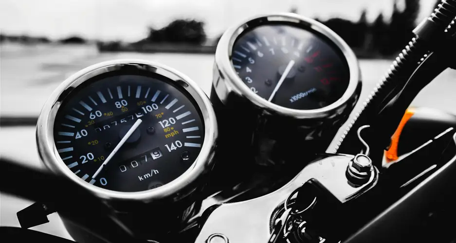 Motorrad-Tacho und Drehzahlmesser auf dem Armaturenbrett, deutlich der Schriftzug km/h sichtbar.